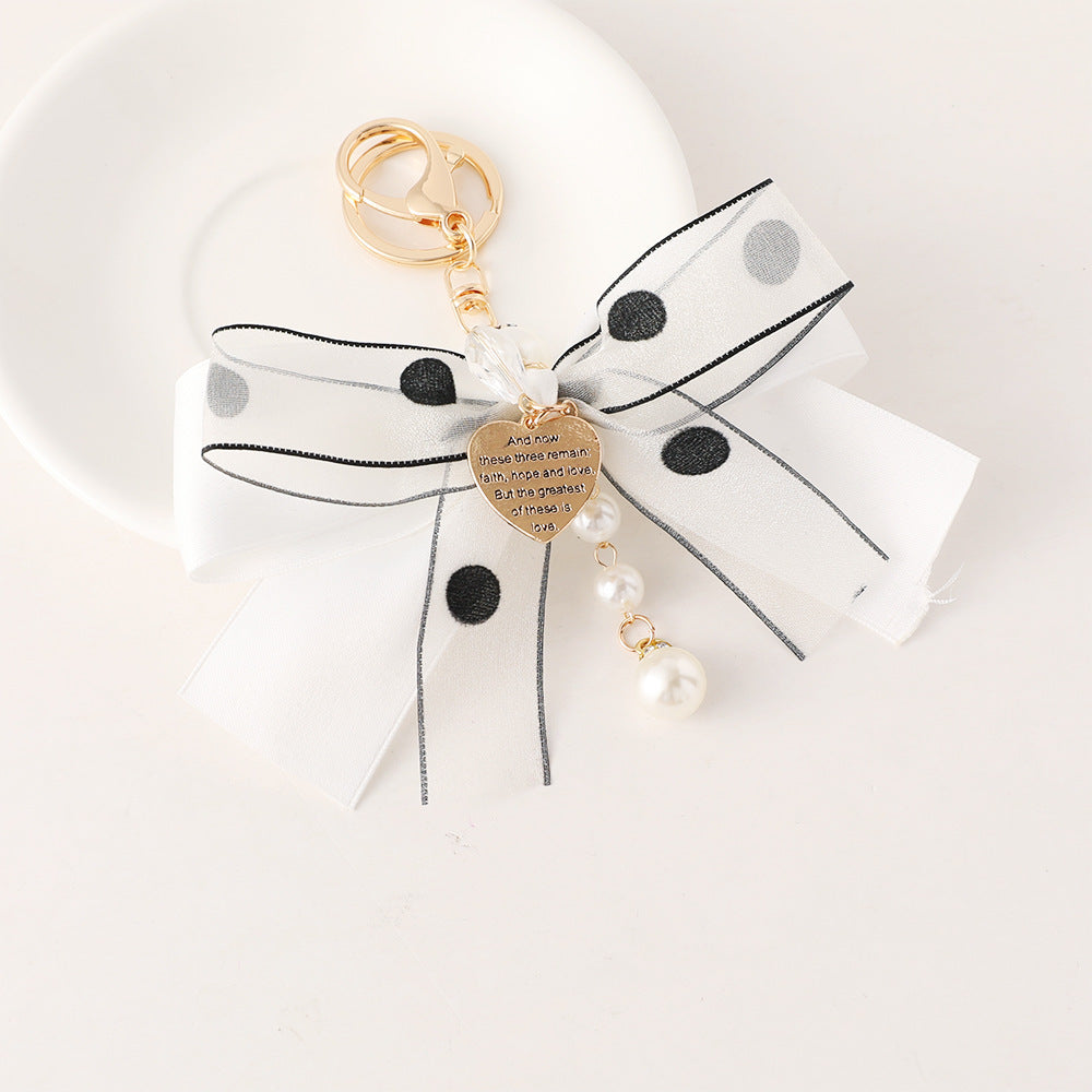 White bow tied keychain