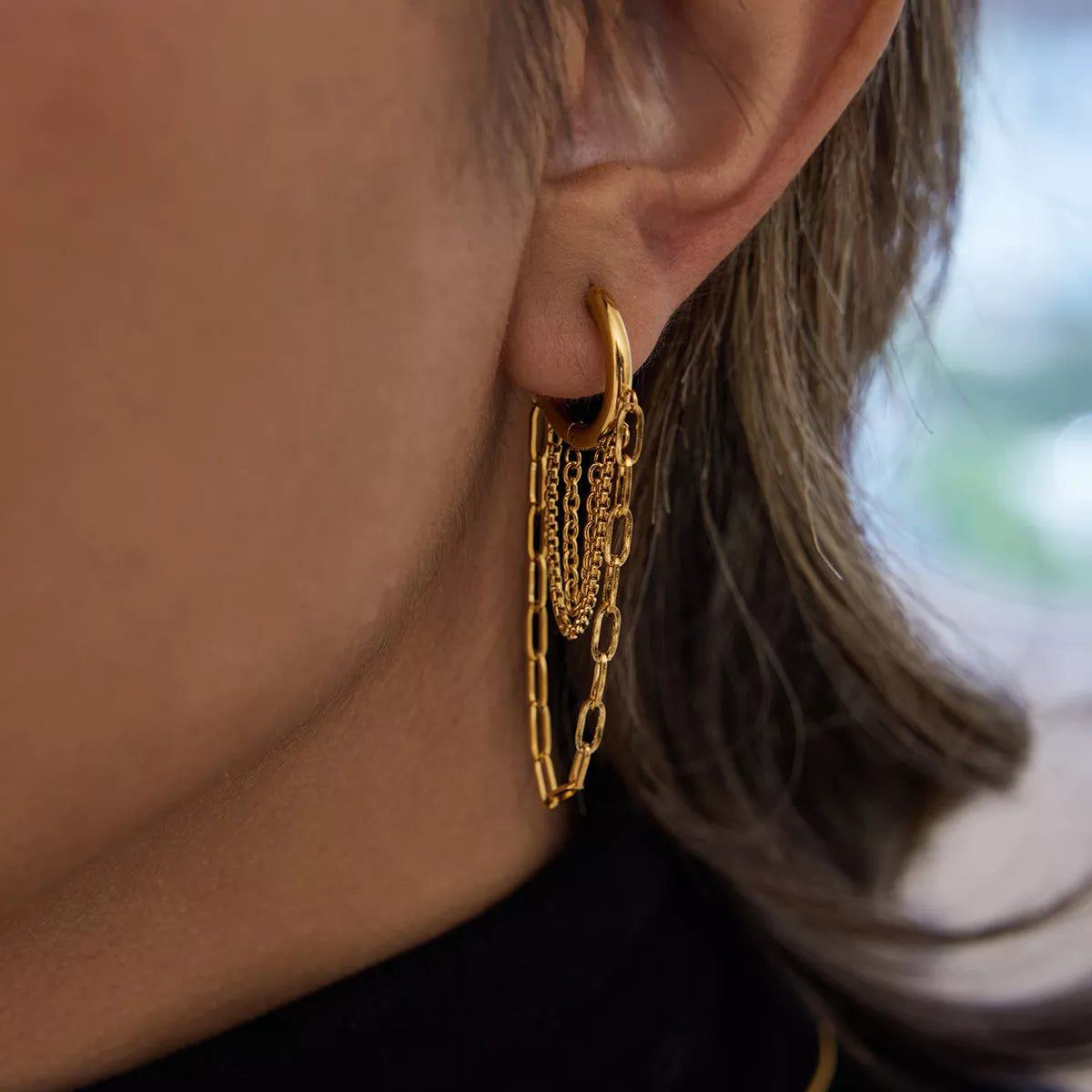 Close-up of an 18K gold plated stainless steel chain hoop earring worn on the ear, showcasing its elegant link design.